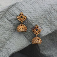Our Classic Jhumka earrings made with unpolished brass placed on a grey background.