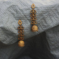 Our Latkan earrings made with unpolished brass placed on a grey background.