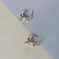 A contemporary yet traditional set of silver kundal earrings. They are both bold and stylish!