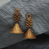 Our Temple Earrings  earrings made with unpolished brass placed on a grey background.